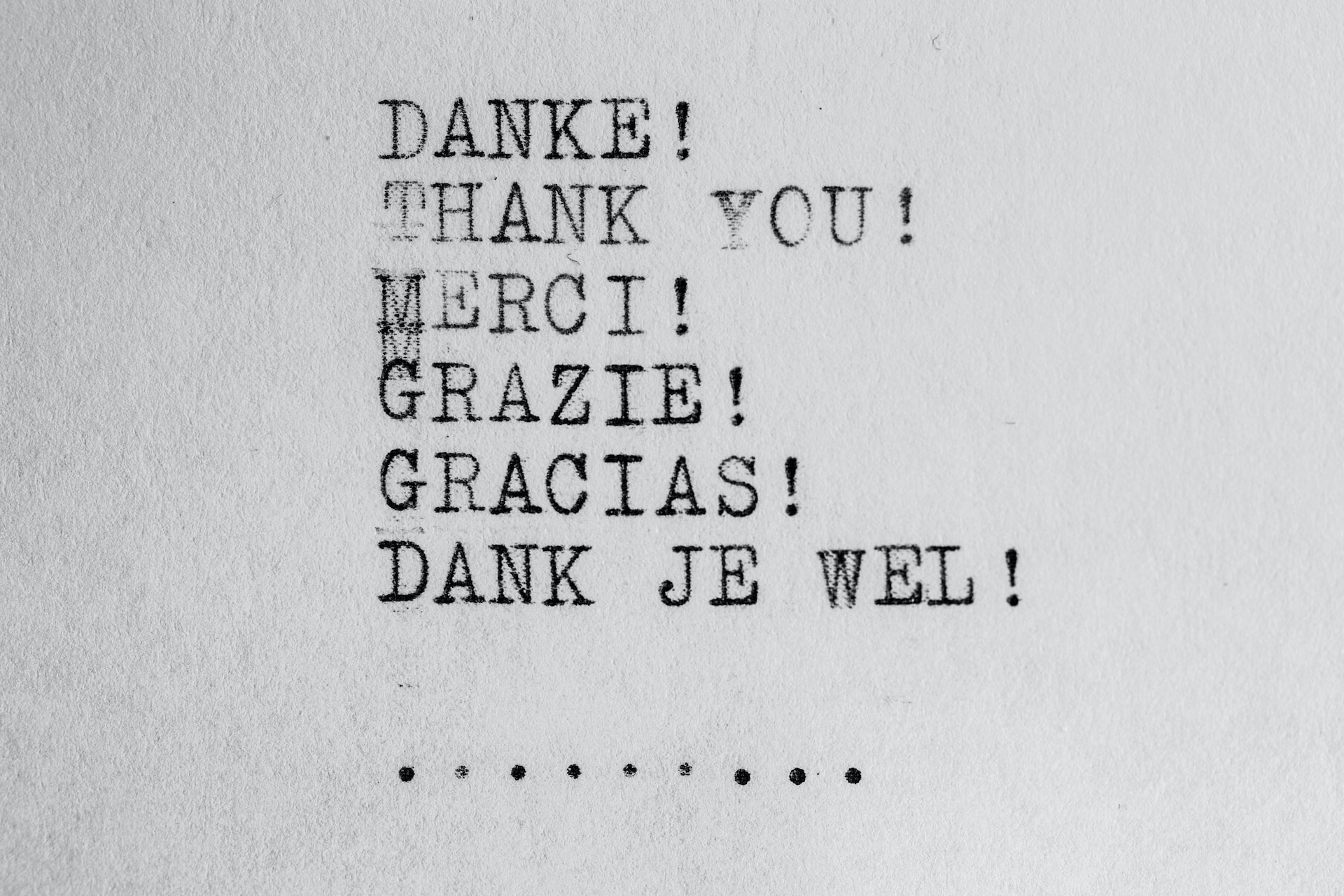 thanks in multiple languages written on a typewriter